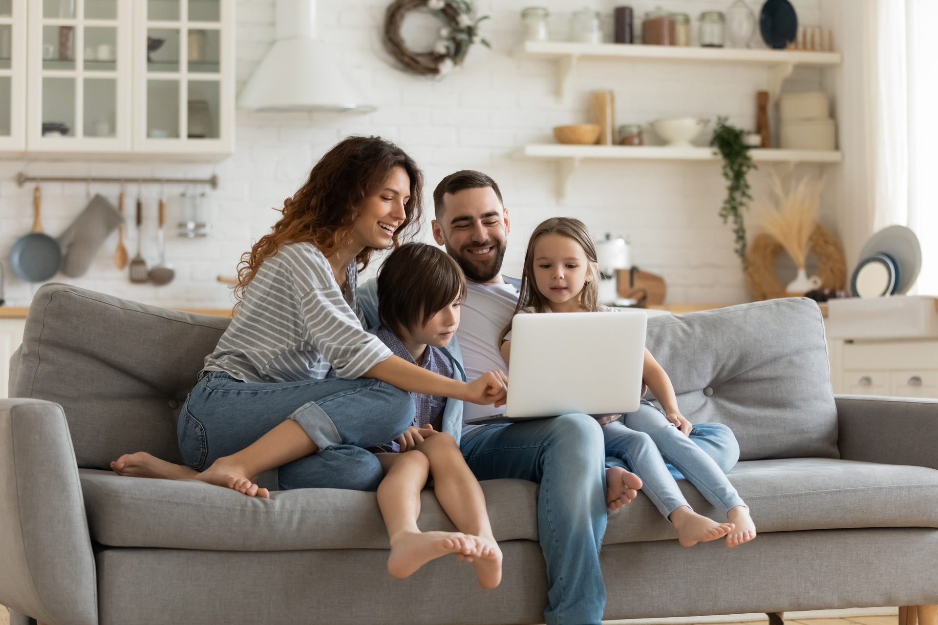Smiling family sitting together on a couch during a supportive family therapy session in Vaughan